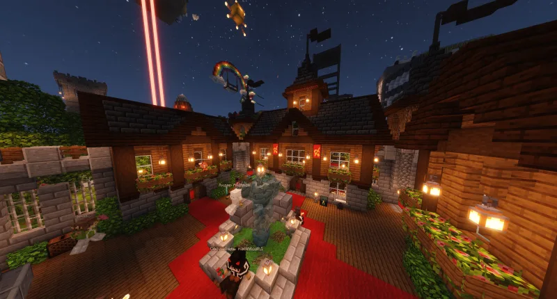 Средневековый замок в Minecraft с фонтаном, красными коврами и фонарями ночью