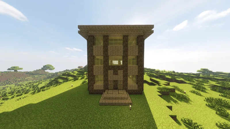 Высокий деревянный дом с окнами и крыльцом на зелёном холме в Minecraft
