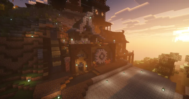Дом инженера в Minecraft с большой шестернёй на фасаде на закате